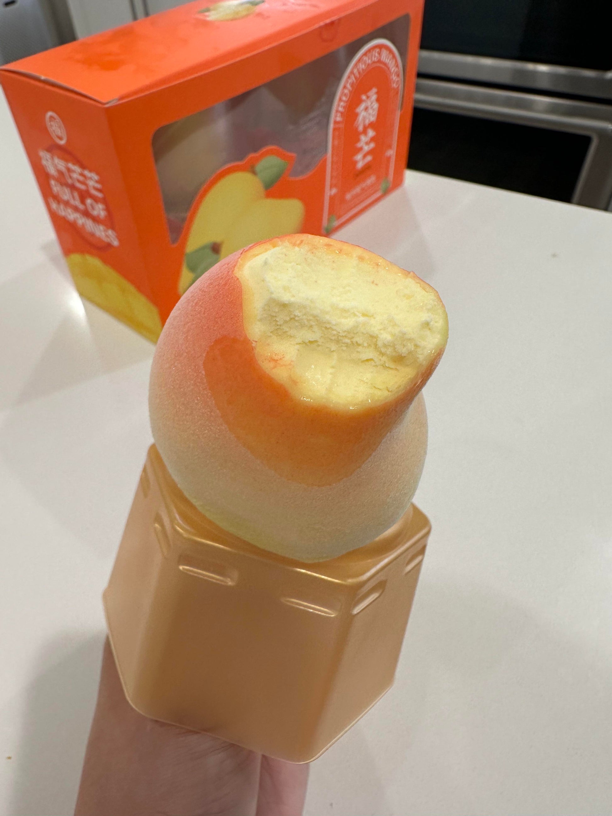 RD International Market mango flavored ice cream bar with creamy texture and bite taken out